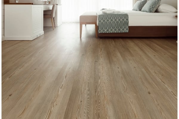 a bedroom with a bed and a wooden floor